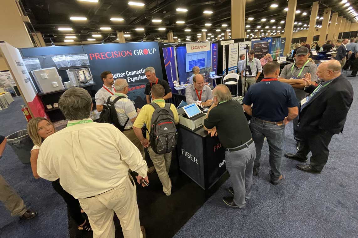 People Standing at Tradeshow Booth Display